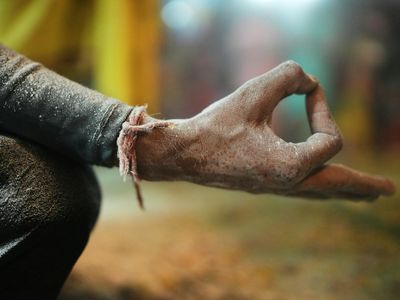 Close-up of hands in a meditative mudra gesture.